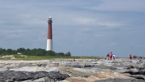 menschen genießen den felsigen steg am leuchtturm von barnegat