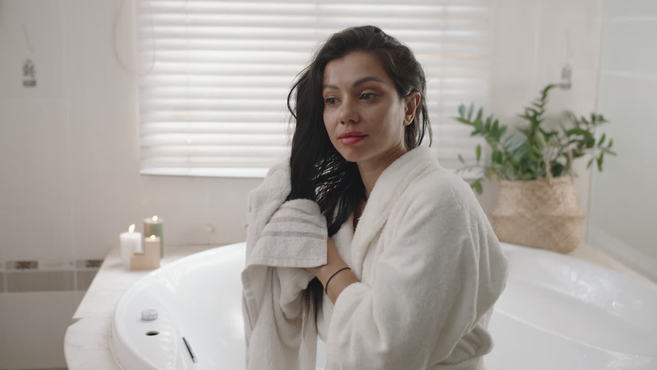 Attractive Woman Wiping Hair with Towel in Bathroom