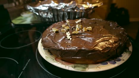 topping homemade chocolate cake with fresh cut walnuts