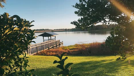 tranquil lakeside view with pier at dawn/dusk