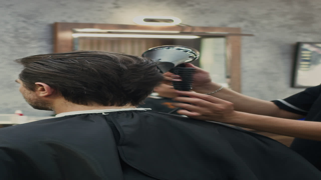 Barber Blow-drying Hair of Client at Salon