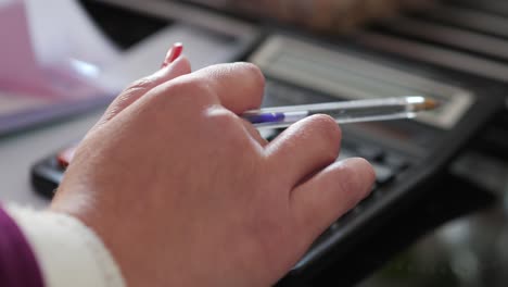 Close-Up-And-Rack-Focus-Of-Female-Bookkeeper-Using-Calculator