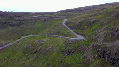 revealing drone shot of twisting road on bealach na ba applecross road through the mountains of the applecross peninsula, in wester ross in the scottish highlands