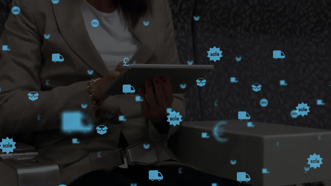 Digital composite video of digital icons against woman using a digital tablet in background