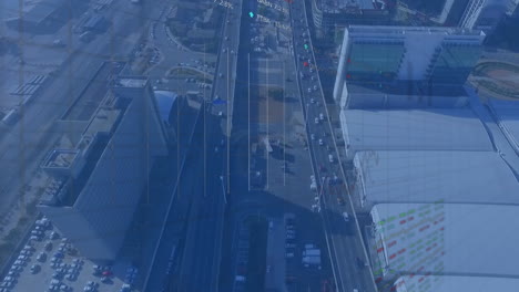 animación del procesamiento de datos estadísticos y bursátiles frente a la vista aérea del tráfico de la ciudad.