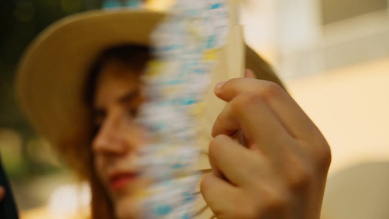 A hand fan held by a female tourist on the island of Capri