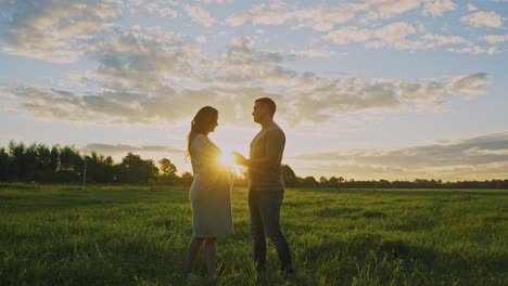 pregnant couple at sunset