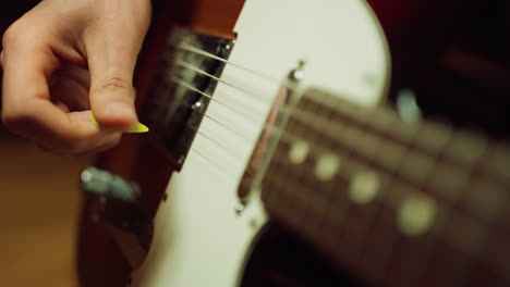 musician playing guitar in recording studio