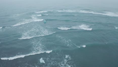drone shot of waves near diamond beach, iceland