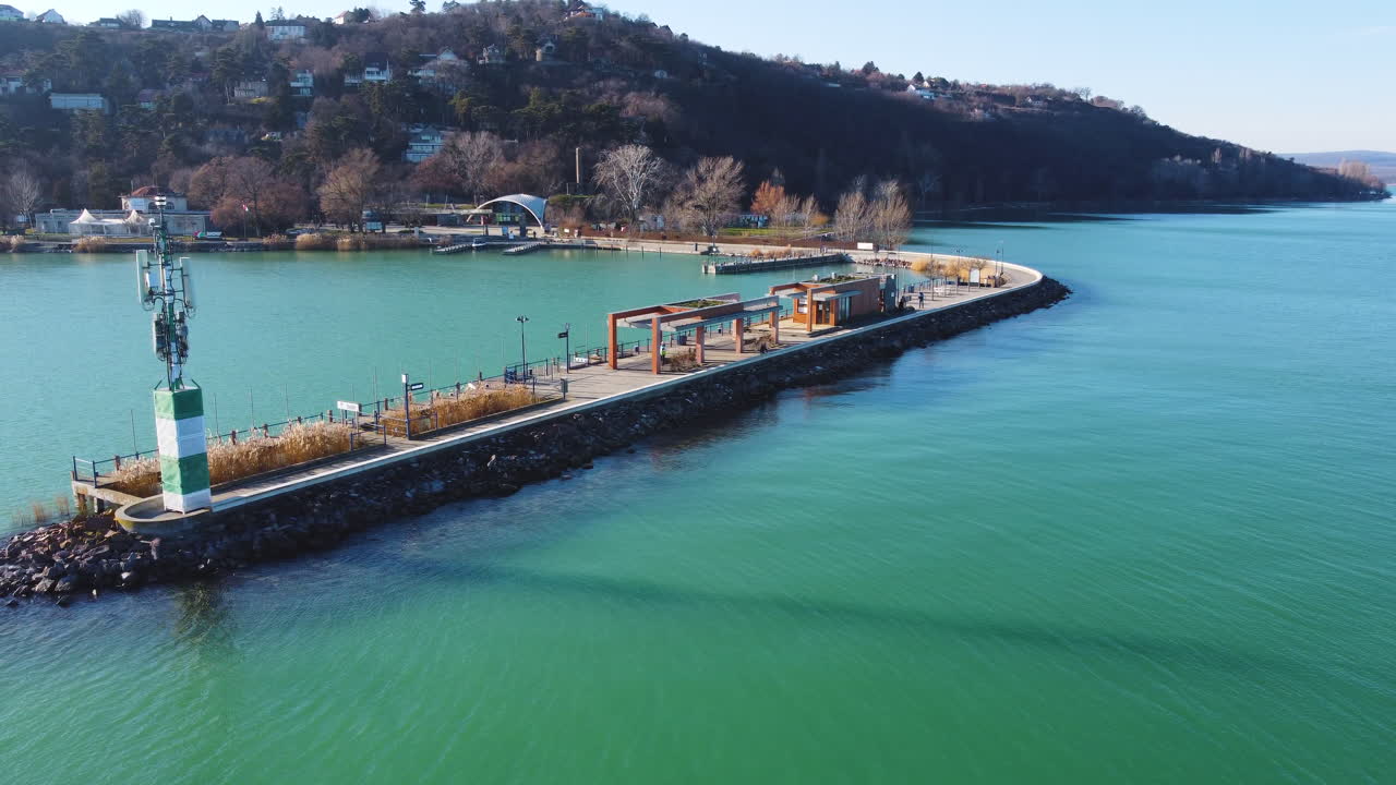 Aerial shot of lakeside village near Hajokikoto with marina and hills along Lake Balaton shore