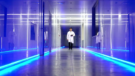 scientists researchers and technicians in a coverall conducting a research, walking through modern laboratory. people with science concept.