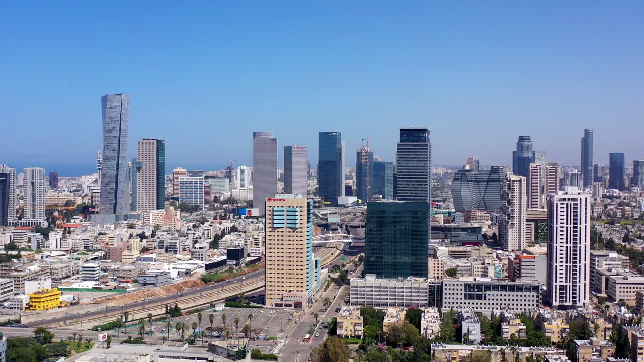 Panoramic view of a modern city skyline with skyscrapers and a highway