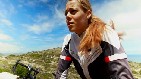 female cyclist repairing bicycle at countryside road 4k