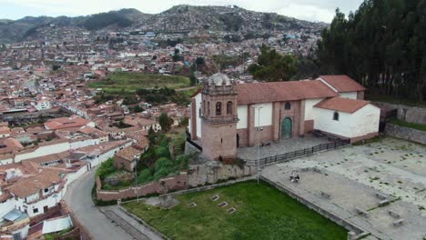 people sitting on churchyard of san cristobal church in cusco, peru