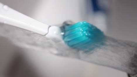 close-up of a toothbrush with blue bristles