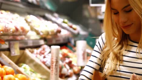 woman buying fruits in organic section