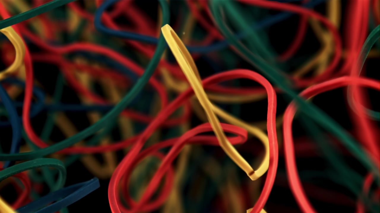 Colorful Rubber Bands Coming into Focus on Black Background