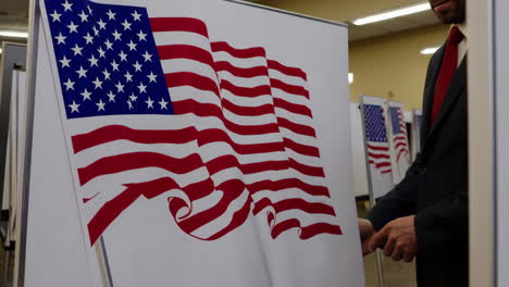 man interacting with an american flag display at an indoor event