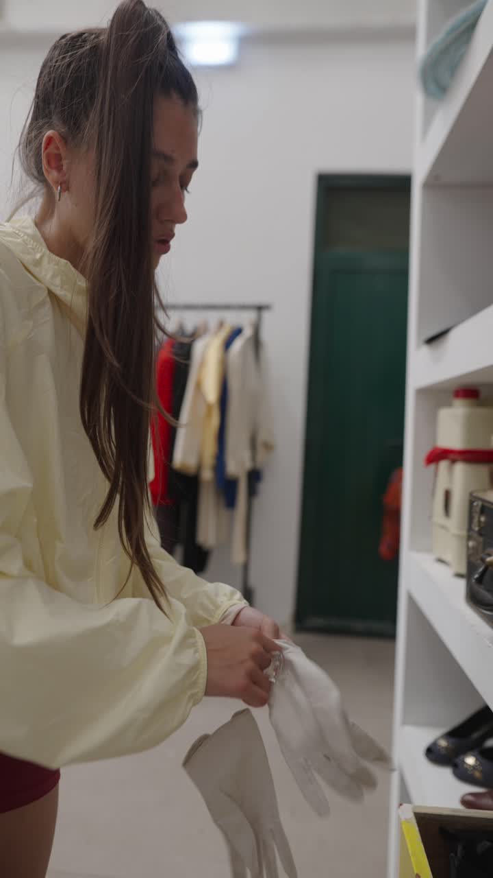Woman trying on white gloves in a clothing store