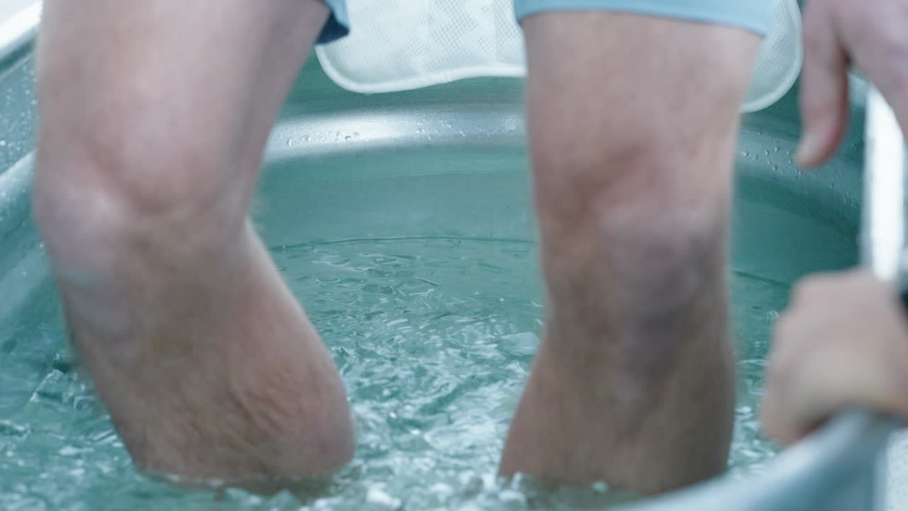 Unidentified Caucasian Man Gets Into A Steel Bathtub Filled With Ice Cubes Trying The Wim Hof Ice Bath Experience