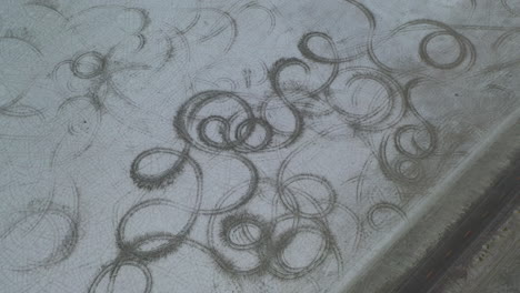 Aerial View of Car Trails on White Soil of Salt Flats by Road