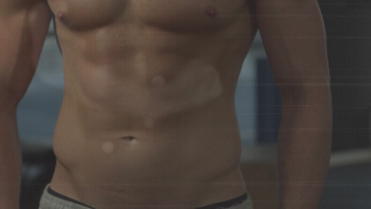 Male athlete posing while camera moving upward, showing abs, chest, turning head, windows