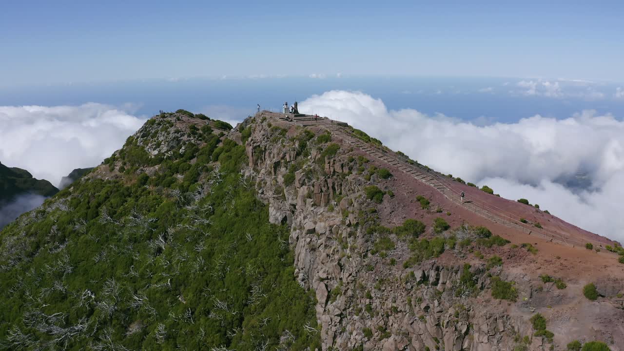 Aerial View of Mountain Peak Above the Clouds