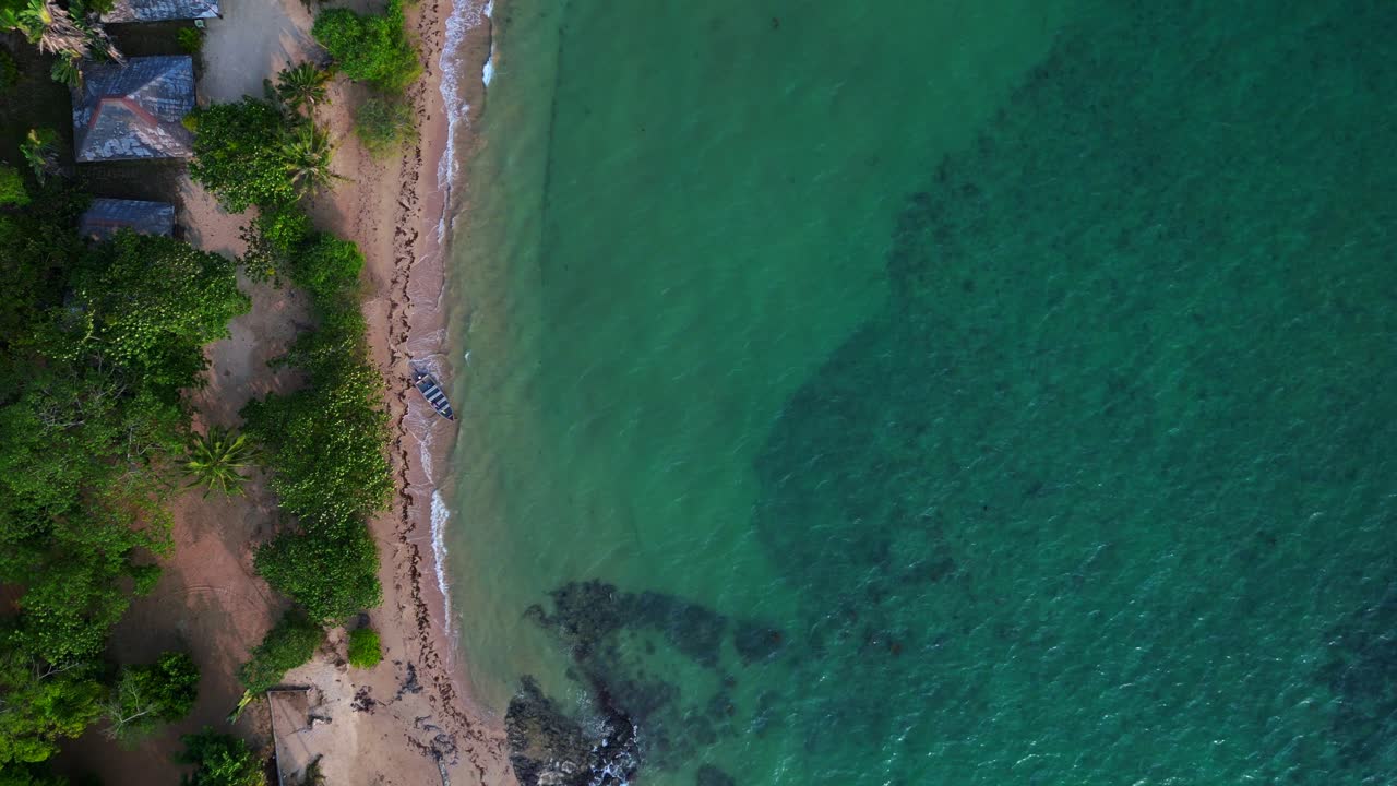 tranquil beach surrounded by dense tropical forest at Koh Mak Island in Thailand. Unbelievable aerial view flight drone camera pointing down