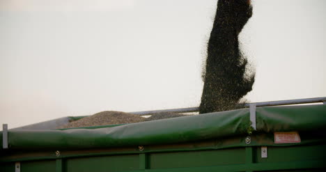 harvester unloading grains against sky 3