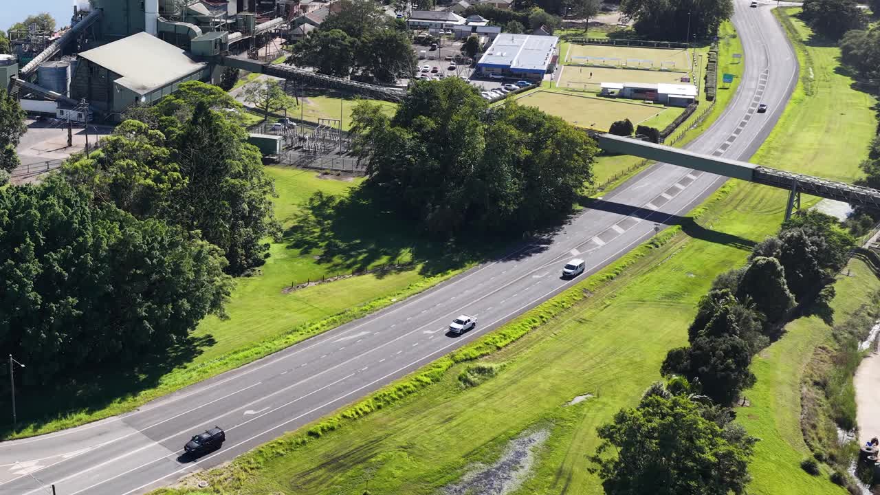 Aerial footage captures the Murwillumbah sugar mill, surrounding roads, and lush greenery under bright daylight