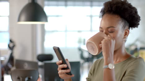 una mujer biracial disfruta de un descanso para un café en la oficina de negocios.
