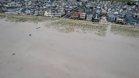 drone shot flying from the ocean to the beach houses at the new jersey shore