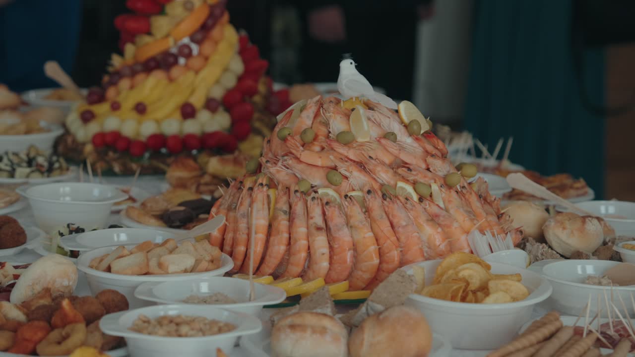Close up of shrimp display surrounded by buffet snacks and dishes