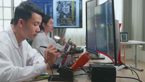 technicians repairing a circuit board