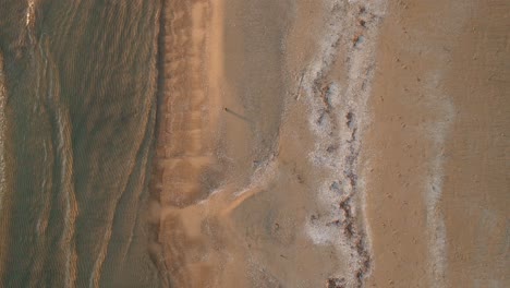 Sandy-shoreline-and-gentle-waves-during-sunset-in-owen-Lake-Huron,-canada,-aerial-view