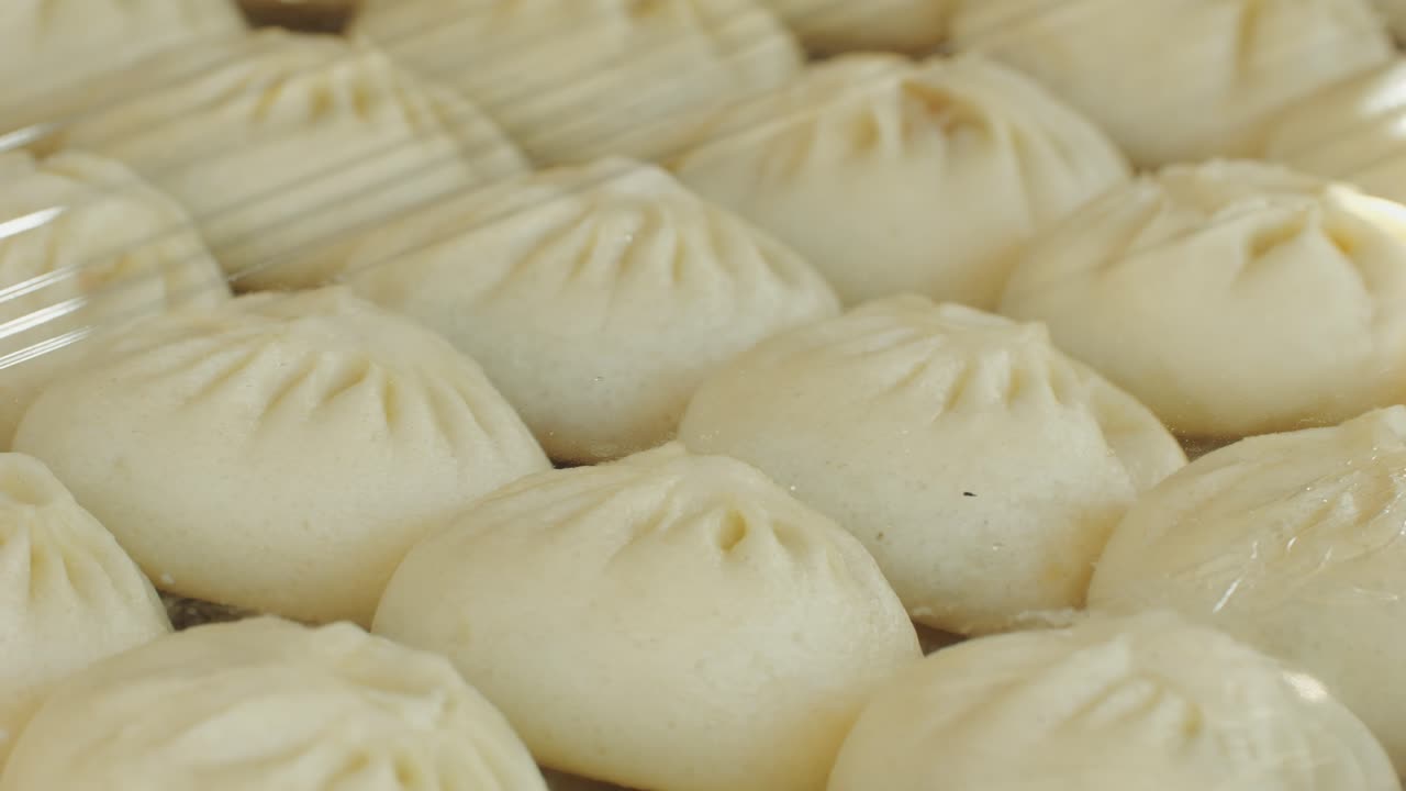 Cooking asian baozi with meat on desk close -up. Steaming Technique.. Street food Chinese and Korean pyanse, fast street food local festival