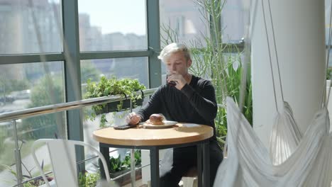 guy eating burger in restaurant