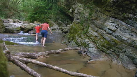 family hiking in a mountain stream