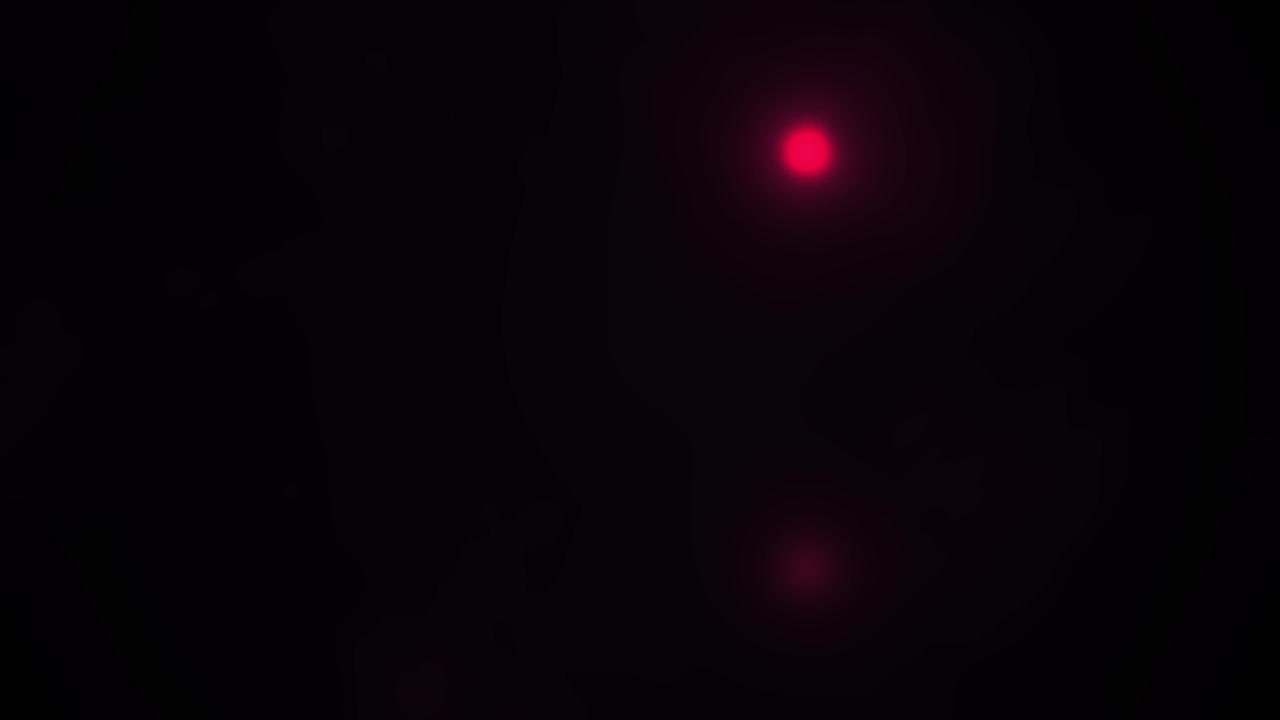 Abstract Red Light Flares Moving Through Dark Background