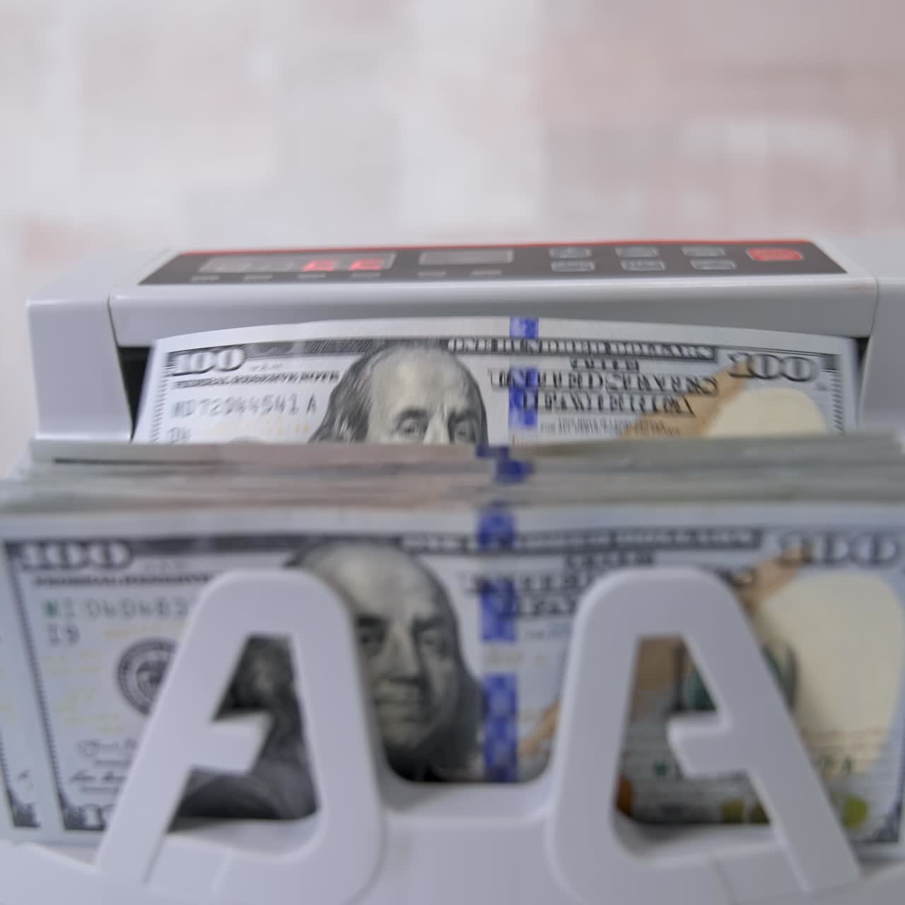 Currency counting machine counts dollar bills. Money counting equipment for paper money calculation. Currency exchange of one hundred dollars. Front view