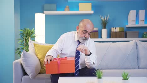 Depressed-old-man-waiting-at-home-unhappy-with-his-gift.