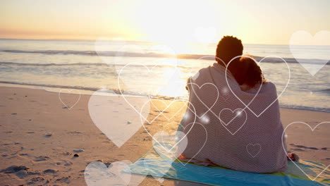 animation of hearts moving over diverse couple in love embracing on beach in summer