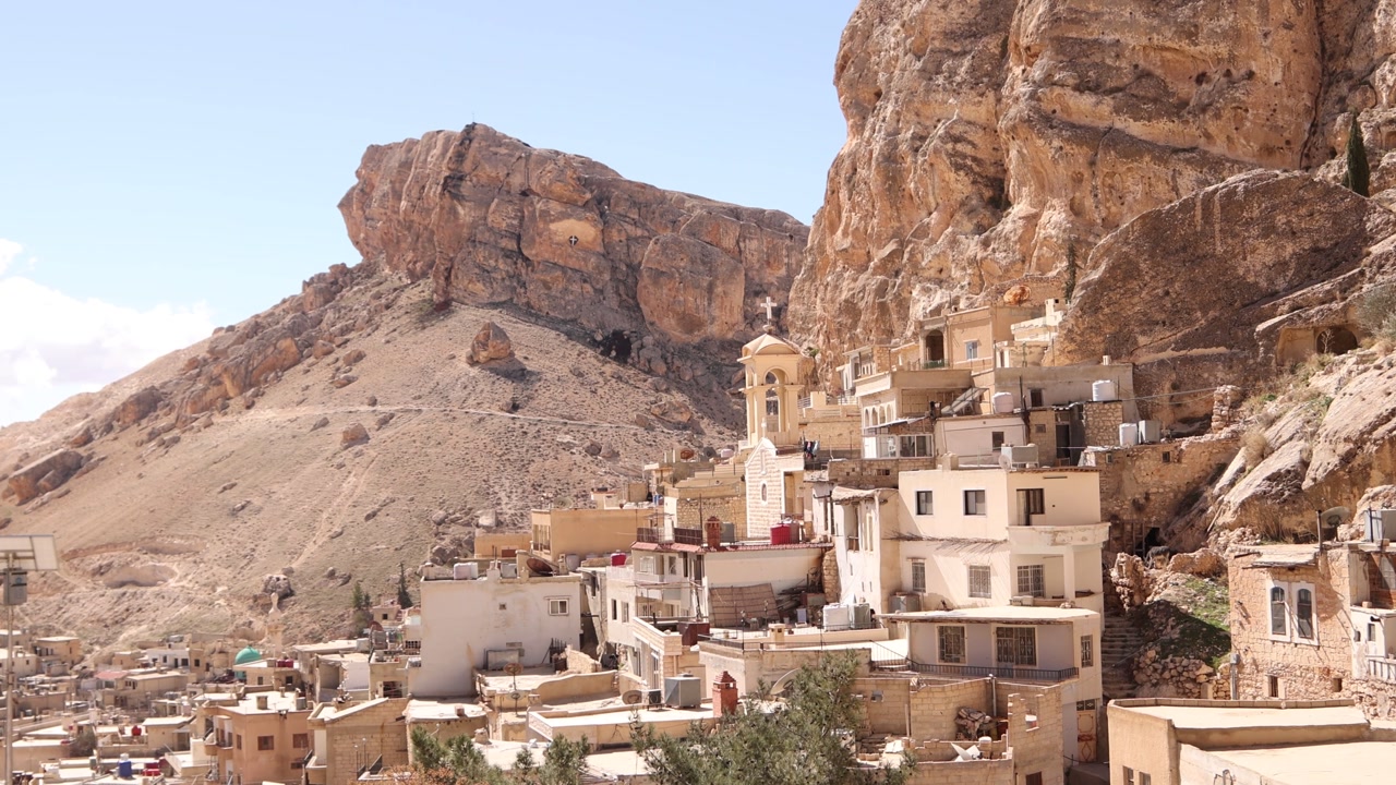 Wide view of the Monastery built into the sheer rocky cliffs of Ma'aloula, Syria. Famous Christian pilgrimage site known for its ancient history and unique mountain architecture