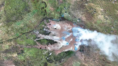 steam from hot springs in hverir geothermal valley in hveragerdi, south iceland - aerial top down