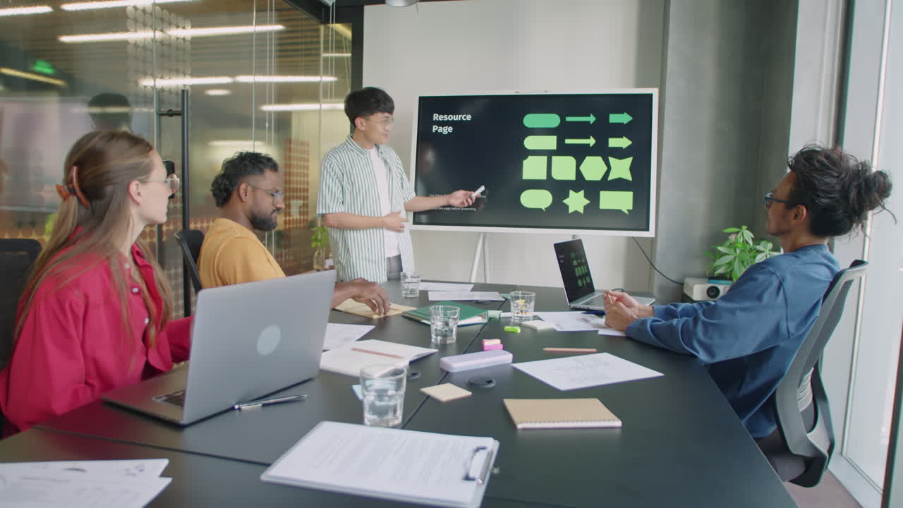 Young Asian Man Giving Presentation on Team Meeting