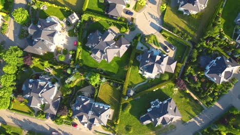 aerial view of residential houses neighborhood and apartment building complex at sunset