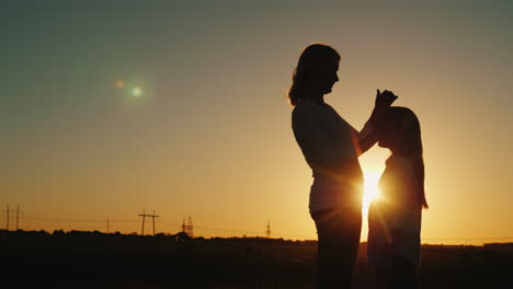 Mother-Caresses-Her-Daughter-Gently-On-The-Head-At-Sunset-Mom-With-A-Baby-Concept-4K-Video