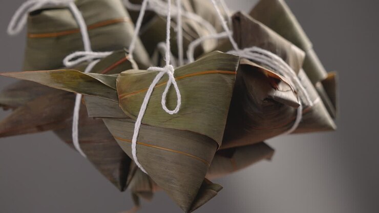 Making zongzi food - preparing and wrapping Chinese rice dumpling.