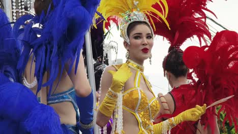 colorful parade with beautiful transgender women in elaborate costumes