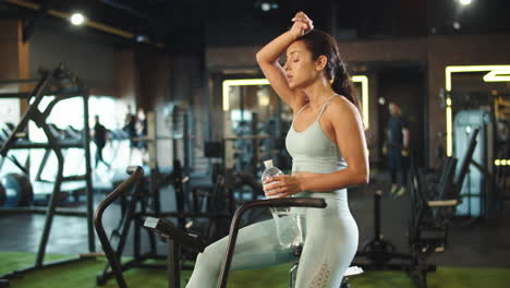 Sport-woman-wiping-sweat-at-gym